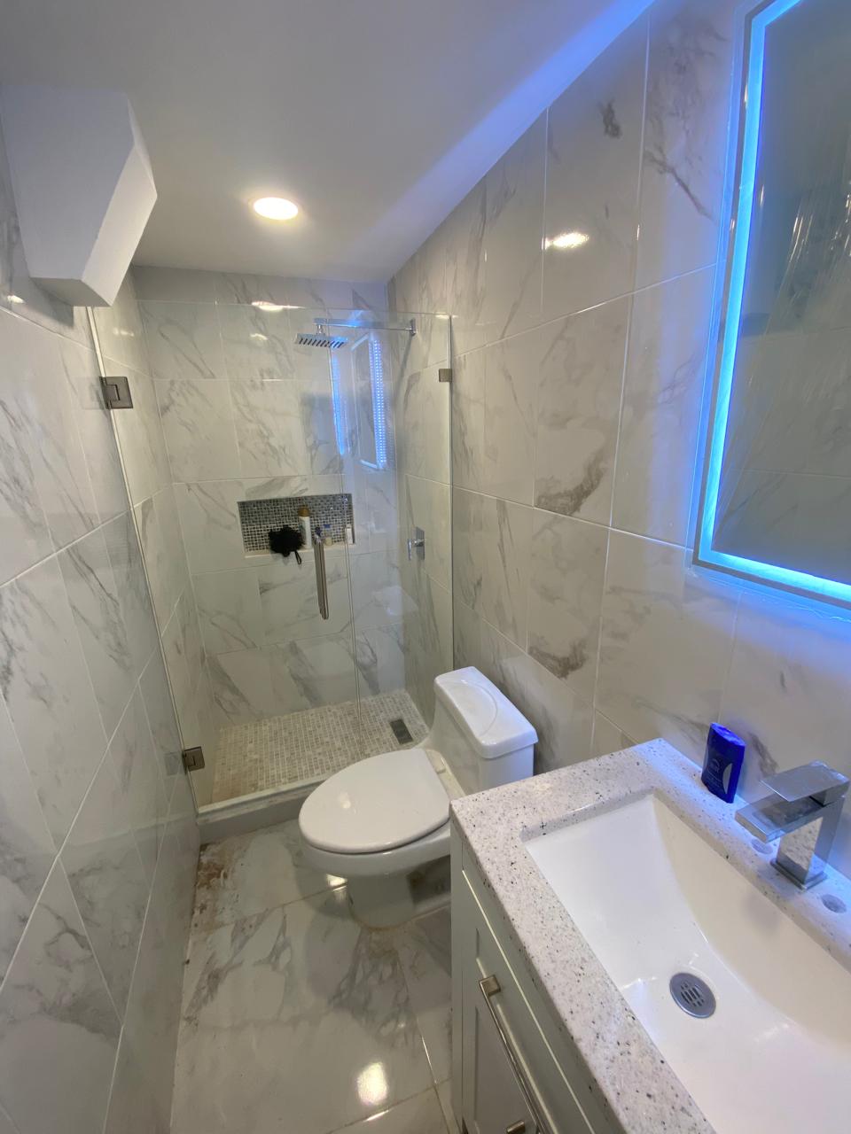 Frameless glass shower enclosure with chrome hardware by FerMac — 2