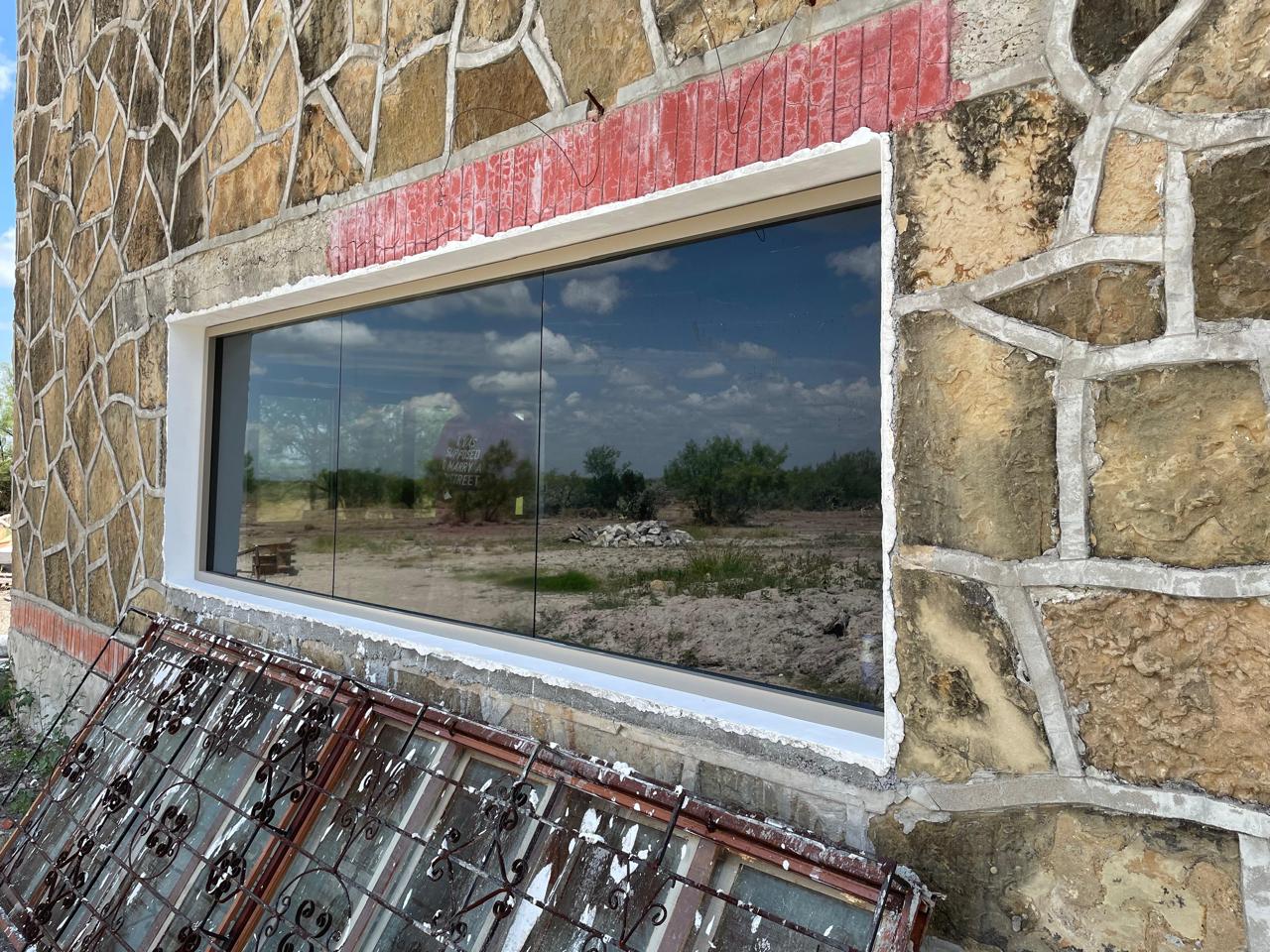 Large panoramic fixed aluminum window with reflective glass by FerMac