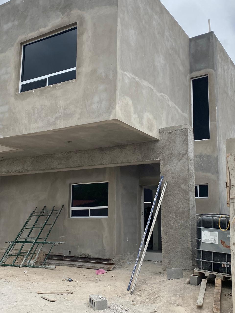 Concrete duplex with tinted aluminum windows by FerMac