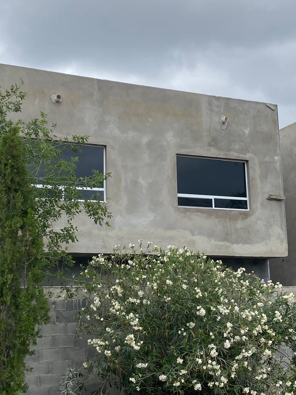 Pair of tinted sliding aluminum windows by FerMac