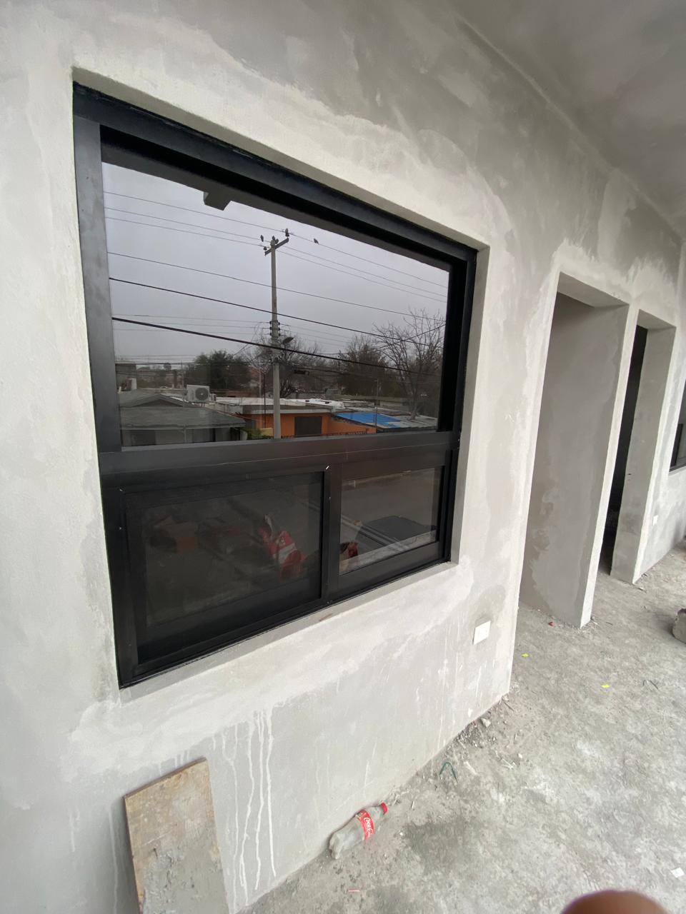 Custom black aluminum window installed by FerMac