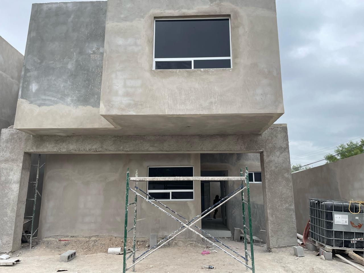 Concrete duplex with tinted aluminum windows by FerMac — 2