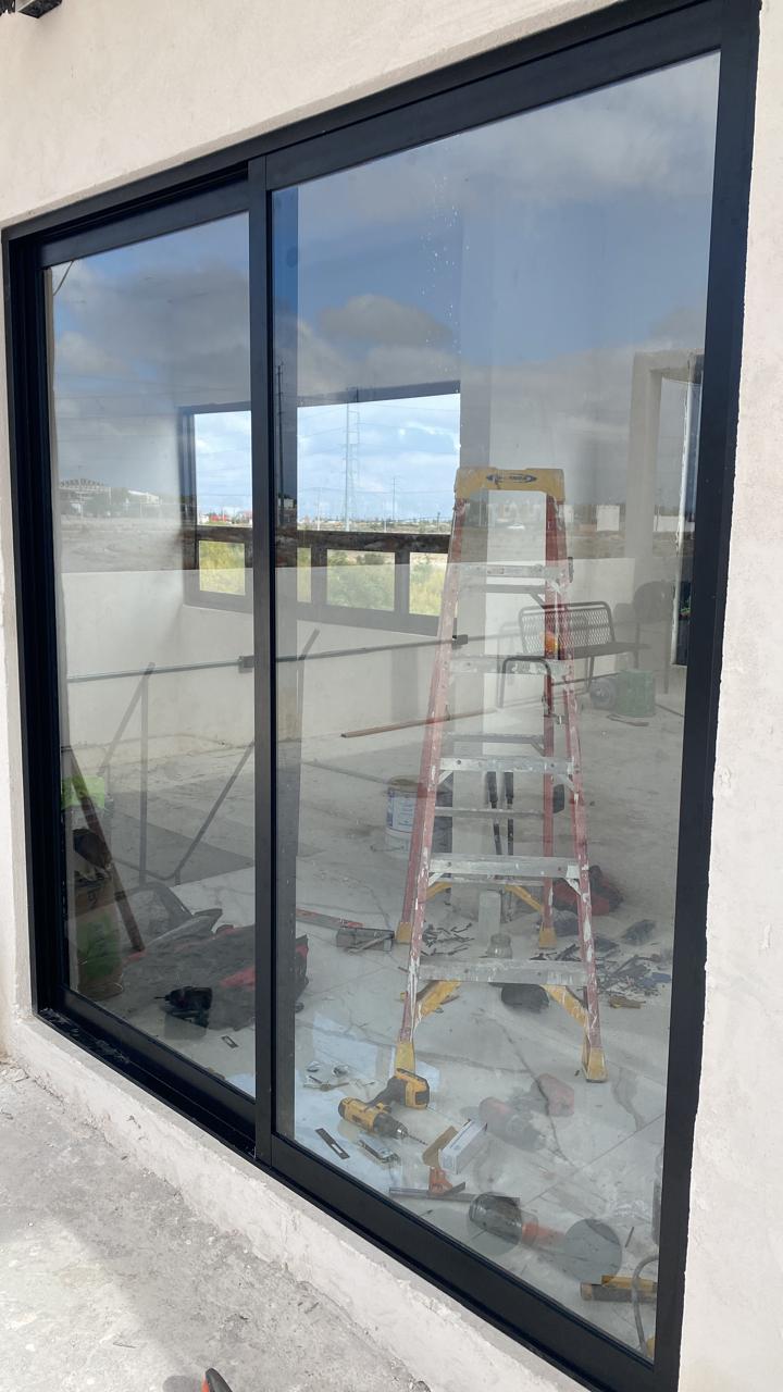 Large black aluminum sliding glass panel by FerMac