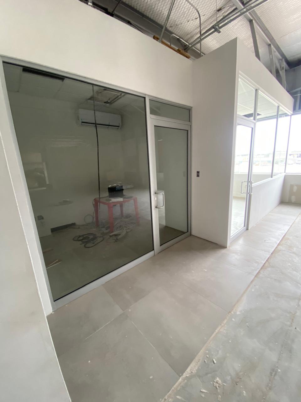 Tinted glass office partition with aluminum door by FerMac