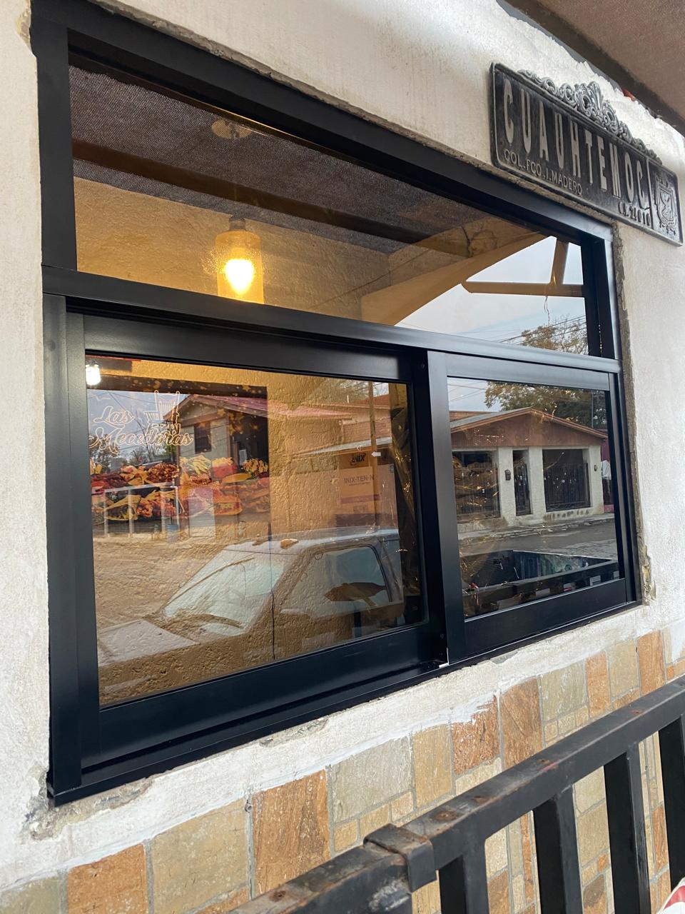 Black aluminum sliding storefront window by FerMac
