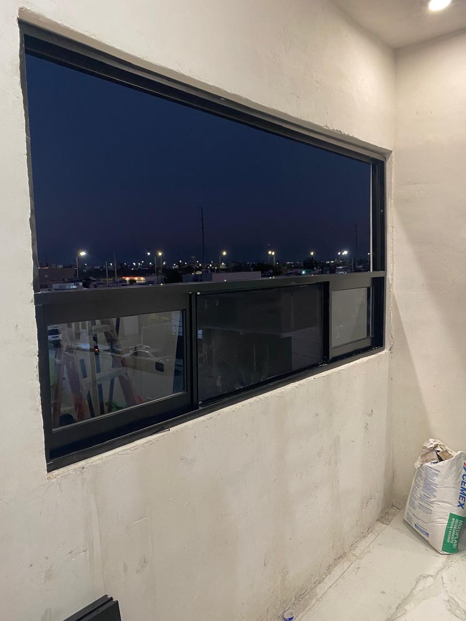 Black aluminum panoramic window with city night view by FerMac